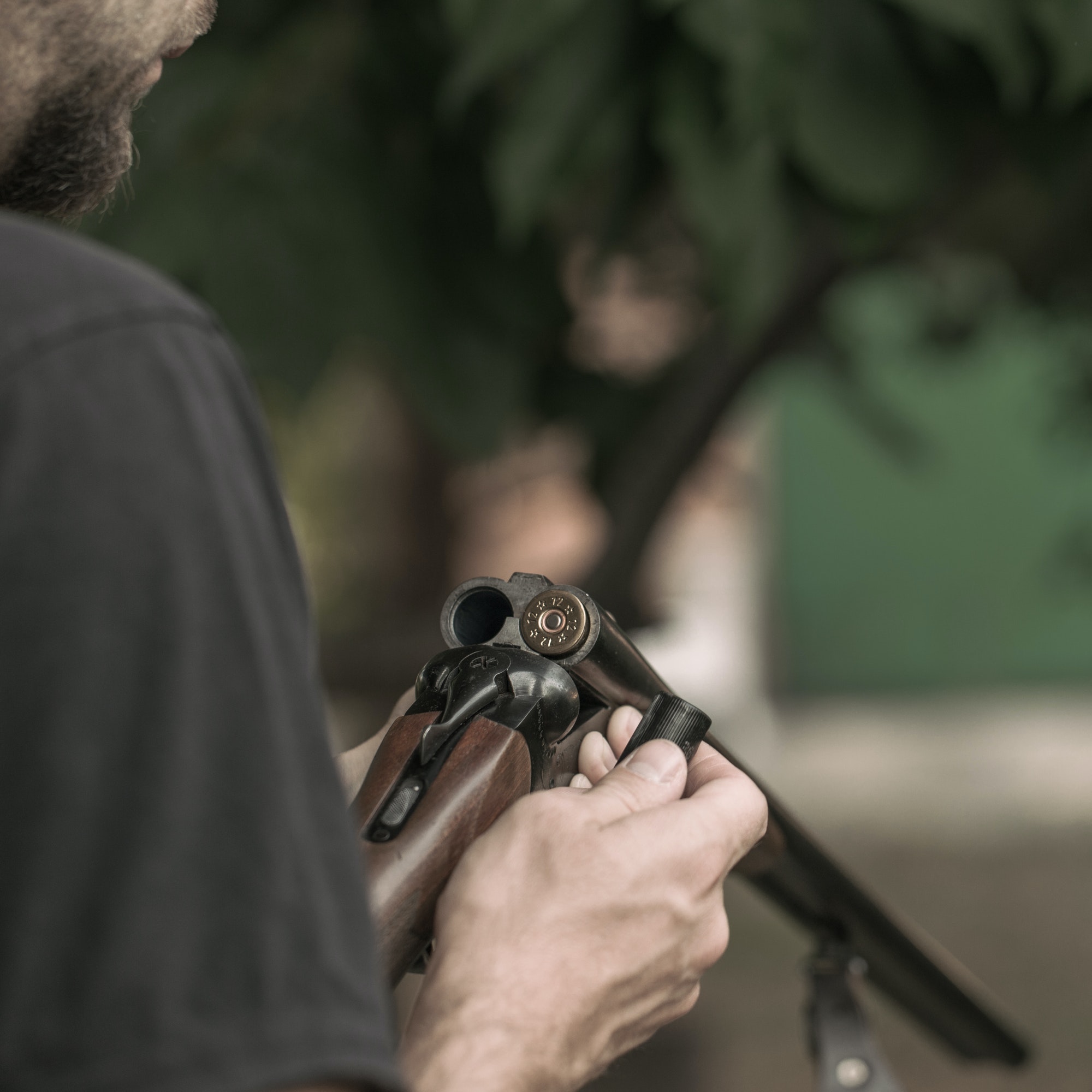 Man charging double-barreled hunting rifle closeup